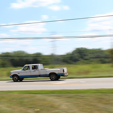 White Extended Cab Truck with Blue Trim Panned Image